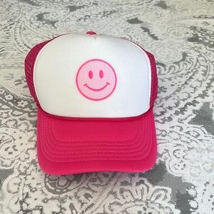Pink and white smiley trucker hat